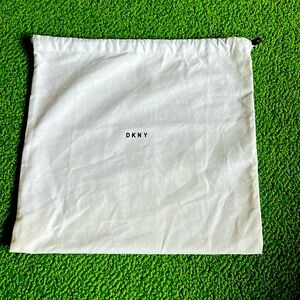 PRELOVED DKNY dust bag. White with black letters . 12 by 11.5 inches